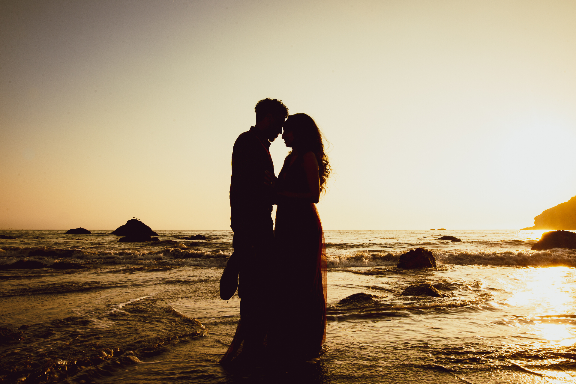 Romantic beach engagement silhouette at sunset